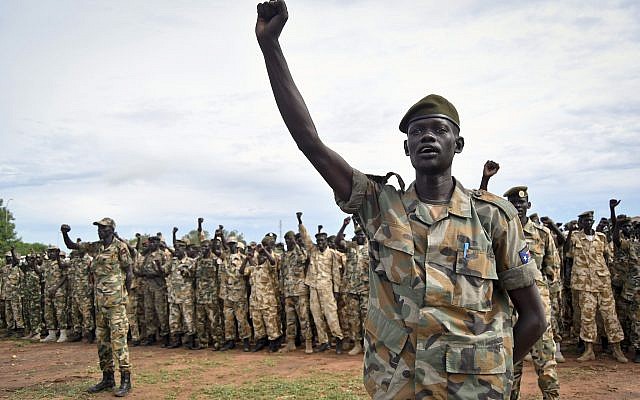 FILE - In this Thursday, May 18, 2017, file photo, soldiers cheer at a ceremony marking the 34th anniversary of the Sudan People's Liberation Army (SPLA), attended by President Salva Kiir, in the capital Juba, South Sudan. (AP /Samir Bol)