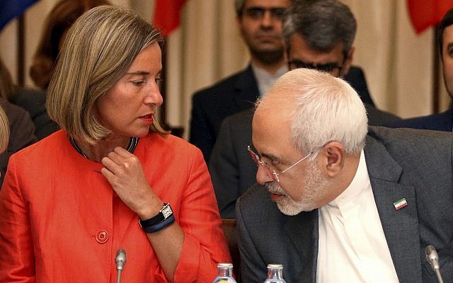 European Union High Representative for Foreign Affairs Federica Mogherini and Iranian Foreign Minister Mohammad Javad Zarif, from left, wait for the start of prior to a bilateral meeting as part of the closed-door nuclear talks with Iran at a hotel in Vienna, Austria, on July 6, 2018. (AP Photo/Ronald Zak)