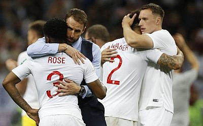 England head coach Gareth Southgate, 2nd left, comforts England's Danny Rose, left, after losing the semifinal match between Croatia and England at the 2018 World Cup in the Luzhniki Stadium in Moscow, Russia, Wednesday, July 11, 2018. (AP Photo/Francisco Seco)