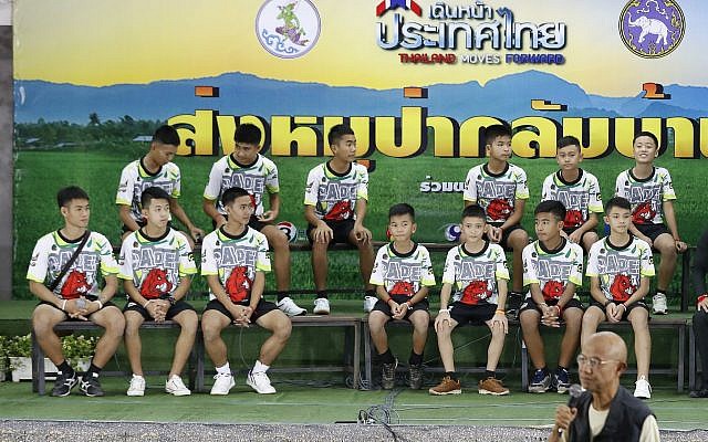 Members of the rescued soccer team and their coach sit during a press conference discussing their ordeal in the cave in Chiang Rai, northern Thailand, July 18, 2018 (AP Photo/Vincent Thian)