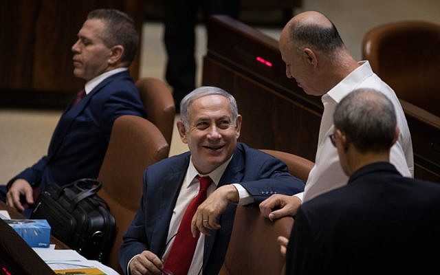Prime Minister Benjamin Netanyahu (C) with cabinet minister Tzachi Hanegbi (CR) at the Knesset plenum on July 18, 2018 (Hadas Parush/Flash90 )