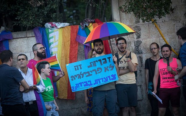 Members of the LGBT community and supporters participate in a demonstration against a Knesset bill amendment denying surrogacy for same-sex couples, outside Prime Minister's Residence in Jerusalem on July 18, 2018. (Yonatan Sindel/Flash90)