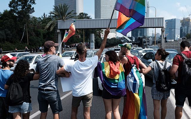 Members of the LGBT community and supporters participate in a demonstration against a Knesset bill amendment denying surrogacy for same-sex couples, in Tel Aviv on July 22, 2018. (Tomer Neuberg/Flash90)