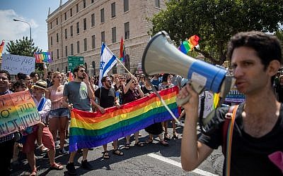 Members of the LGBT community and supporters participate in a demonstration against a Knesset bill amendment denying surrogacy for gay men, in Jerusalem on July 22, 2018.  (Yonatan Sindel/Flash90)