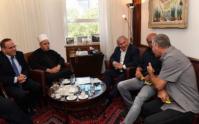 Prime Minister Benjamin Netanyahu (C) meets with Sheikh Muafak Tariff, spiritual leader of Israel's Druze community, Communications Minister Ayoub Kara (L) and other Druze leaders at his office in Jerusalem to discuss the nation-state law on July 27, 2018. (Kobi Gideon/GPO/Flash90)