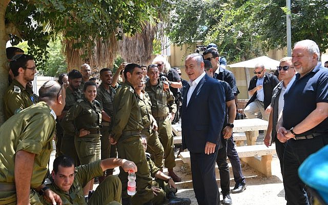 Prime Minister Benjamin Netanyahu meets with soldiers during a visit to the IDF’s Gaza Division on July 17, 2018, amid an increase in violence from the Gaza Strip. (Kobi Gideon/GPO)