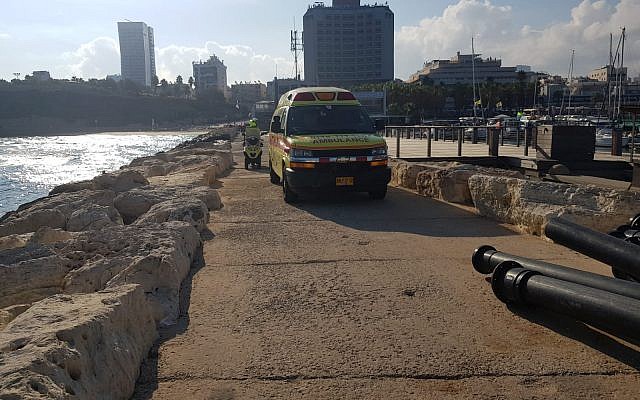 Paramedics on the Tel Aviv waterfront recover a 19-year-old woman's body, July 30, 2018. (Magen David Adom)