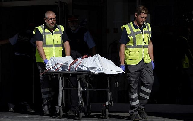 The body of a man who tried to attack a police station is carried out of the premises in Cornella near the northeastern Spanish city of Barcelona on August 20, 2018. (LLUIS GENE/AFP)
