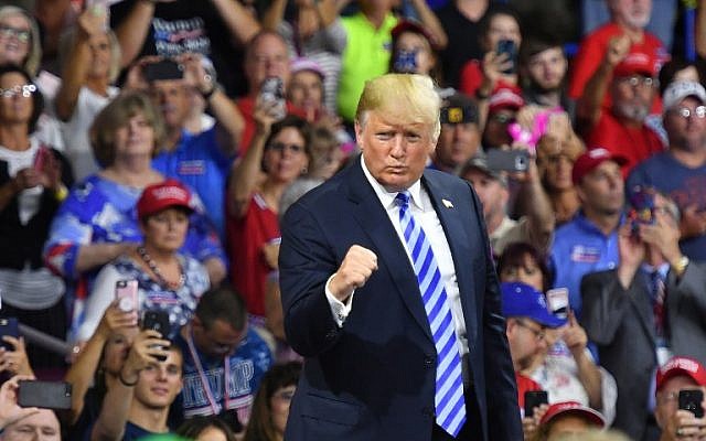 US President Donald Trump salutes his supporters after speaking at a political rally at Charleston Civic Center in Charleston, West Virginia on August 21, 2018. (AFP/Mandel Ngan)
