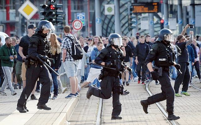 Riot police cross the street as a city festival is cancelled on August 26, 2018 in Chemnitz, eastern Germany, after a 35-year-old German national dies in hospital following a 'dispute between several people of different nationalities,' according to the police. (AFP Photo/dpa/Andreas Seidel)