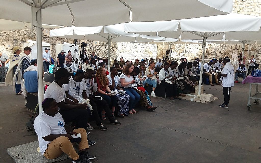 Members of the Ugandan-Jewish Abuyudaya community in Israel on a Birthright trip organized by MAROM participate in a ceremony celebrating the dedication of a new Torah scroll at the Western Wall's pluralistic prayer pavilion, August 27, 2018. (Courtesy MAROM)