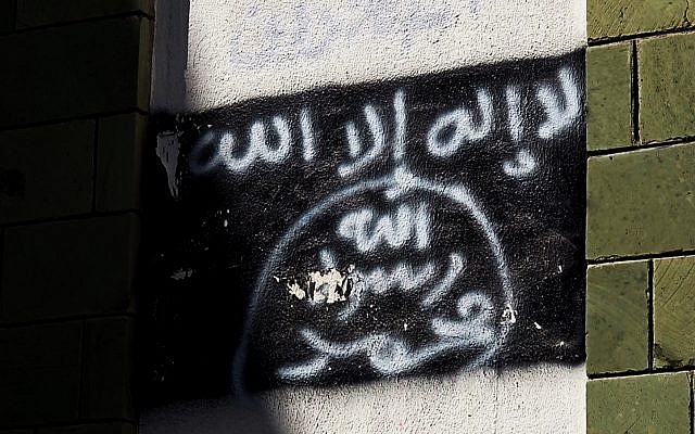 The black al-Qaeda flag is sprayed on the wall of a damaged school that was turned into a religious court, in Taiz, Yemen, shown in this October 16, 2017 photo. (AP Photo)
