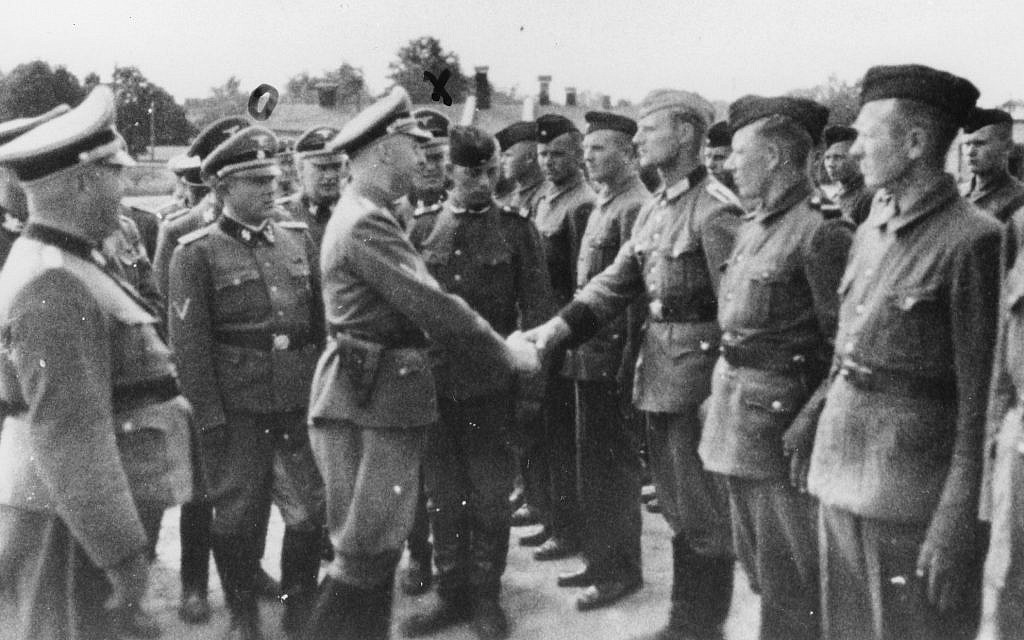 This 1942 photo provided by the the public prosecutor's office in Hamburg via the United States Holocaust Memorial Museum, shows Heinrich Himmler, center left, shaking hands with new guard recruits at the Trawniki concentration camp in Nazi occupied Poland. (public prosecutor's office in Hamburg via the United States Holocaust Memorial Museum via AP)