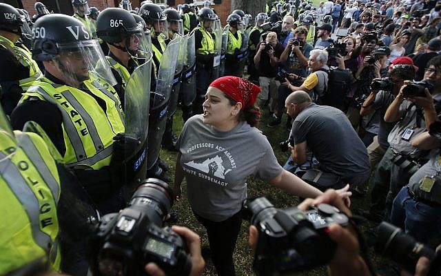 A protester confronts riot gear-clad police on the campus of the University of Virginia during a rally to mark the anniversary of last year's Unite the Right rally in Charlottesville, Virginia, Saturday, Aug. 11, 2018. (AP/Steve Helber)