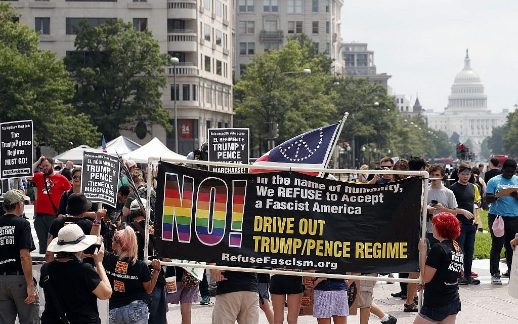Protesters gather in Freedom Plaza with the US Capitol in the background, on the one year anniversary of Charlottesville's "Unite the Right" rally, Sunday, August 12, 2018, in Washington. (AP Photo/Alex Brandon)