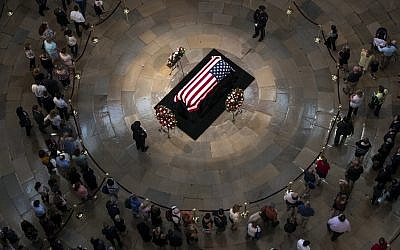 Members of the public walk past the flag-draped casket bearing the remains of John McCain of Arizona, who lived and worked in Congress over four decades, in the US Capitol rotunda in Washington, Friday, Aug. 31, 2018. (AP/J. Scott Applewhite)