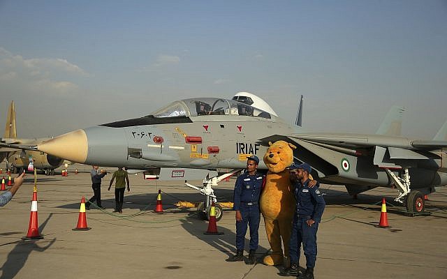 In this September 23, 2015 file photo, Iranian soldiers take a picture with a Winnie the Pooh character next to a F-14 fighter jet in an exhibition of achievements and equipment of Iran's air force in Tehran, Iran. (AP/Ebrahim Noroozi)