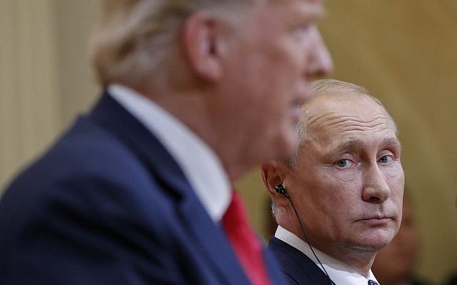 Russian President Vladimir Putin (right) looks toward US President Donald Trump, as Trump speaks during a joint news conference in Helsinki, Finland, July 16, 2018. (AP/Pablo Martinez Monsivais)