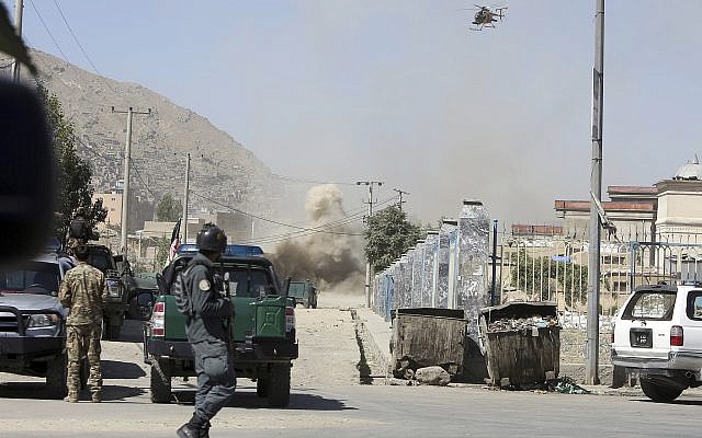 An MD 530F military helicopter targets a house where attackers are hiding in Kabul, Afghanistan, August 21, 2018. (AP Photo/Rahmat Gul)