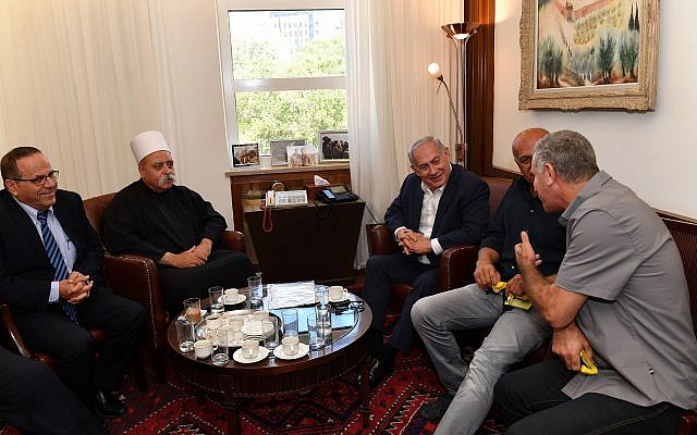 Prime Minister Benjamin Netanyahu, 2r, meets with the spiritual leader of the Druze community in Israel, Sheikh Muafak Tarif, 2l, at the Prime Minister’s Office in Jerusalem on July 27, 2018. (Kobi Gideon/GPO)