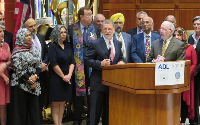 Rabbi Bruce Lustig of Washington Hebrew Congregation is surrounded by clergy of multiple faiths as he helps launch a weekend of counterprotests against white supremacist marchers in Washington, D.C., Aug. 10, 2018. (Ron Kampeas)