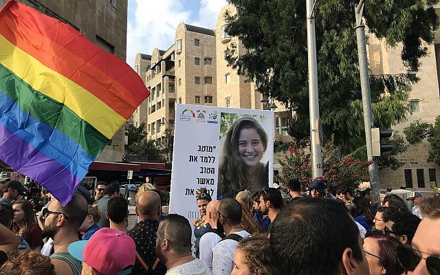 File: Jerusalem Pride Parade marchers on August 2, 2018 carry a poster commemorating 16-year-old Shira Banki, murdered by an ultra-Orthodox extremist in a pride march in the capital in 2015. (Luke Tress/The Times of Israel)