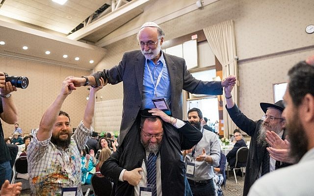 Robert Meeropol and Rabbi Efraim Mintz dance at a conference of the Rohr Jewish Learning Institute. (Mendy Moskowitz/Rohr Jewish Learning Institute via JTA)