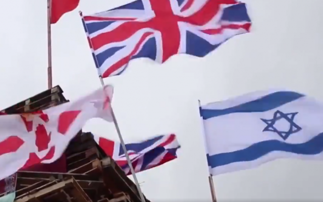 British and Israeli flags on a bonfire that was later set ablaze on August 15, 2018 in Derry, Northern Ireland. (Screenshot: Twitter)