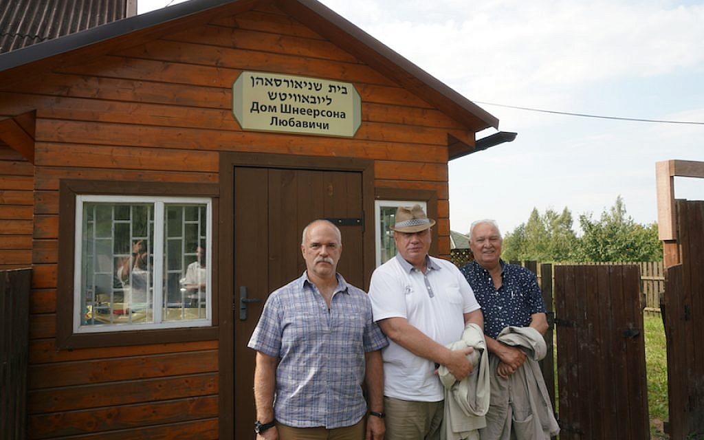 District Mayor Yuri Ivashkin, center, and his employees stand outside a Jewish cemetery in Lyubavichi, August 26, 2018. (Cnaan Liphshiz)