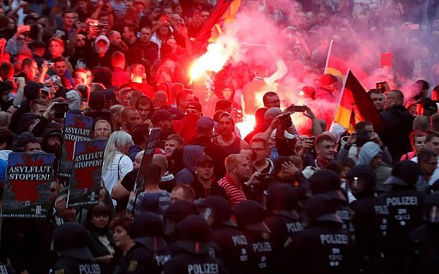 Far-right demonstrators light flares in Chemnitz, eastern Germany, on September 7, 2018, after a 35-year-old German was stabbed to death in August 2018. (AFP/Odd Andersen)