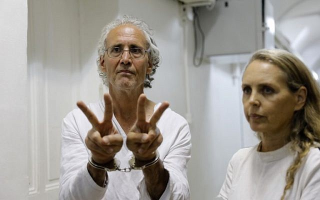American-French law professor Frank Romano gestures at the Jerusalem court on September 16, 2018. To his right is his lawyer Gaby Lasky. US-born Romano, who teaches law at the Paris Nanterre University, was detained two days ago while taking part in a demonstration at the Bedouin village of Khan al-Ahmar, east of Jerusalem. (AFP PHOTO / Ahmad GHARABLI)