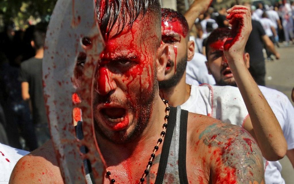 Shiite Muslims flagellate themselves as they mark Ashura, on September 20, 2018 in Lebanon's southern town of Nabatieh.(AFP PHOTO / Mahmoud ZAYYAT)