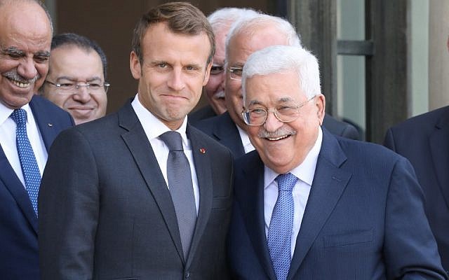 French President Emmanuel Macron (L) poses with Palestinian Authority President Mahmoud Abbas after their meeting with the French president at the Elysee Palace in Paris on September 21, 2018. (AFP/Ludovic Marin)