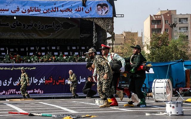 Illustrative: Iranian soldiers carrying away an injured colleague at the scene of an attack on a military parade that was marking the anniversary of the outbreak of its devastating 1980-1988 war with Saddam Hussein's Iraq, September 22, 2018, in the southwestern Iranian city of Ahvaz. (AFP/ ISNA / MORTEZA JABERIAN)