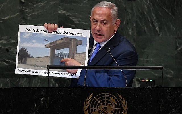 Prime Minister Benjamin Netanyahu addresses the General Assembly at the United Nations in New York September 27, 2018, holding up a picture of an alleged Iranian ‘atomic warehouse (Timothy A. Clary/AFP)
