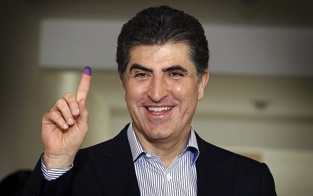 Nechirvan Barzani, prime minister of Iraq's autonomous Kurdistan Regional Government (KRG), shows his ink-stained index finger after casting his ballot for the parliamentary election at a polling station in Erbil, the capital of the Kurdish autonomous region in northern Iraq, on September 30, 2018. (AFP PHOTO / SAFIN HAMED)