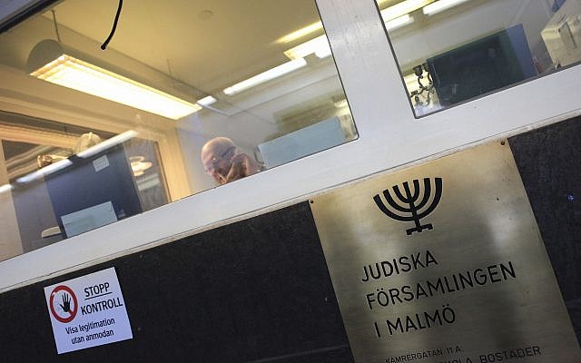 Illustrative: In this March 3, 2010 photo, a man sits behind a glassed-in reception area of the high security Jewish community center located in central Malmo, Sweden. (AP Photo/Pamela Juhl)