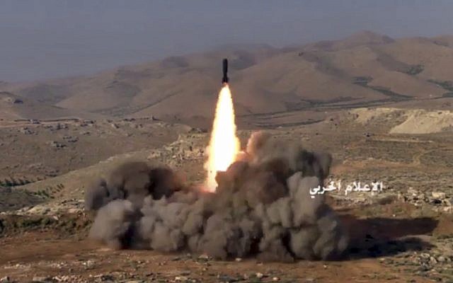 This frame grab from video released on July 22, 2017, and provided by the government-controlled Syrian Central Military Media, shows Hezbollah fighters firing a missile at positions of al-Qaeda-linked militants in an area on the Lebanon-Syria border. (Syrian Central Military Media, via AP)