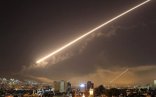 In this April 14, 2018 file photo, Damascus skies erupt with surface to air missile fire as the U.S. launches an attack on Syria targeting different parts of the Syrian capital Damascus, Syria. (AP/Hassan Ammar)