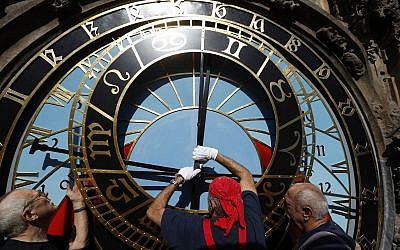 Workers adjust repaired parts of the famed astronomical clock at the Old Town Hall in Prague, Czech Republic, September 11, 2018. (AP Photo/Petr David Josek)