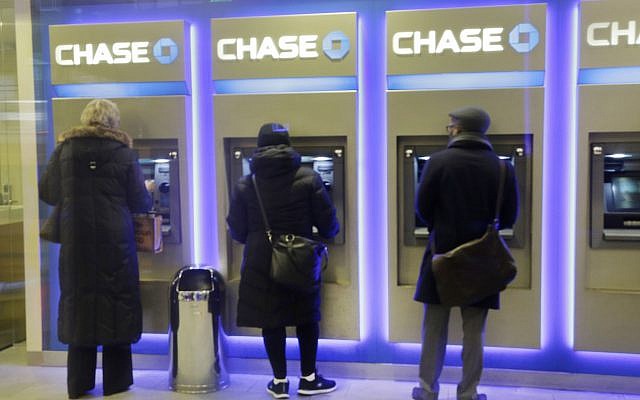 Customers using ATM machines at a branch of Chase Bank in New York, January 14, 2015. (AP/Mark Lennihan)