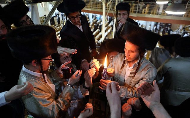 Ultra-Orthodox men seen lighting the 'Havdallah' candle marking the end of the Jewish Sabbath, inside a synagogue in the town of Uman, Ukraine, during the Jewish holiday of Rosh Hashanah. September 7, 2013. (Yaakov Naumi/Flash90)