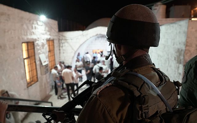 Illustrative: An IDF soldiers looks on as Jewish worshipers arrive at the Joseph's Tomb holy site in the northern West Bank city of Nablus on September 26, 2018. (IDF)
