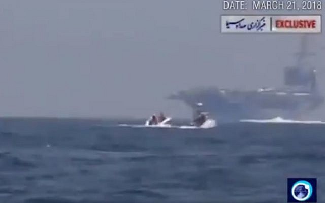 A still from a video published by Iranian state media showing a boat approaching a US carrier in March, 2018. (screen capture: Twitter)