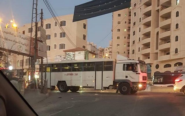 An Israeli military bus after it accidentally entered the Qalandiya refugee camp north of Jerusalem in the central West Bank on September 16, 2018. (Twitter)
