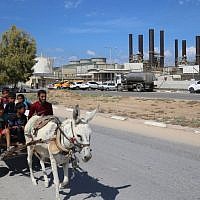 Palestinians ride a donkey near the Gaza power plant in Nuseirat, in the central Gaza Strip October 9, 2018. (AFP Photo/Said Khatib)