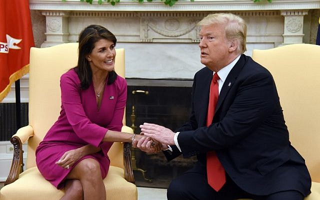 US President Donald Trump shakes hands with Nikki Haley, the United States Ambassador to the United Nations  in the Oval office of the White House on October 9, 2018 in Washington, DC. (AFP PHOTO / Olivier Douliery)