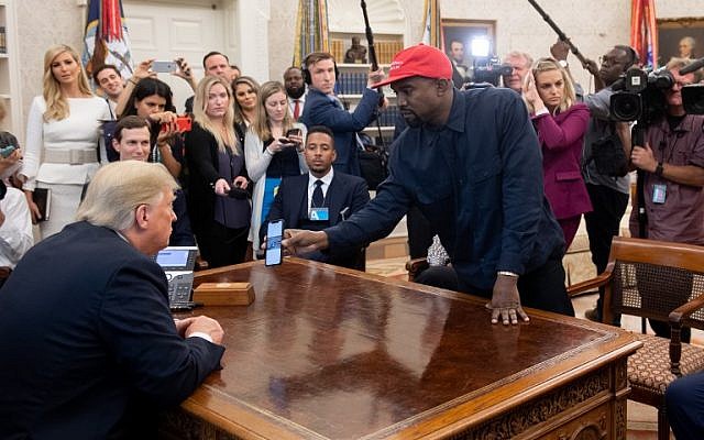 US President Donald Trump meets with rapper Kanye West, right, in the Oval Office of the White House in Washington, DC, on October 11, 2018. (Photo by SAUL LOEB / AFP)