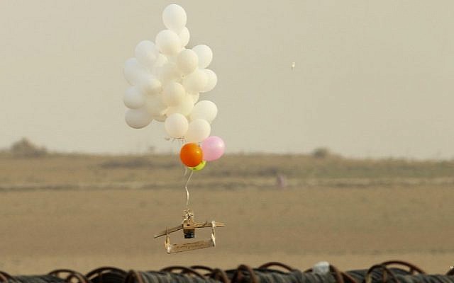 Illustrative. This picture taken on October 19, 2018 in Nahal Oz, from the Israeli side of the border with the northeast of the Gaza Strip, shows balloons carrying an alleged incendiary device launched by Palestinian protesters. (Photo by JACK GUEZ / AFP)