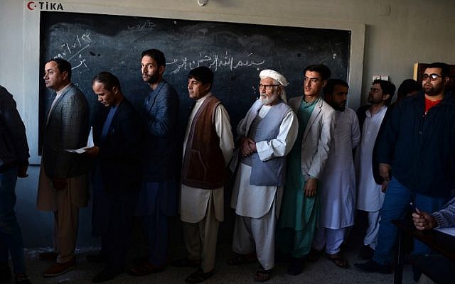 Afghan men line up to cast their vote at a polling centre for the country's legislative election in Mazar-i-Sharif on October 20, 2018. (FARSHAD USYAN / AFP)